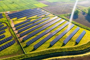 Solar Energy Farm in Fields. Aerial Drone View.